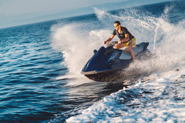 One young man driving water scooter